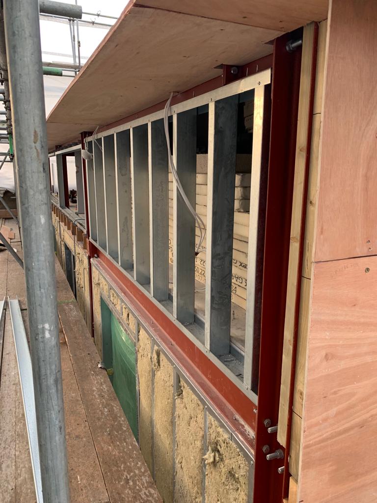 External wall metal stud insulation brick course